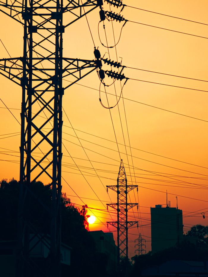 The Art of Drawing Readers In: Your attractive post title goes here Silhouettes of electric pylons against a sunset sky, highlighting industrial infrastructure.
